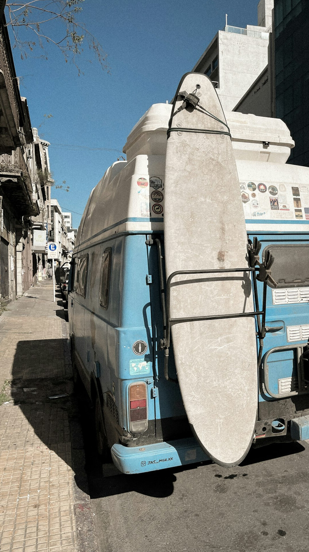 Archival style photograph of a vintage automobile parked on a historic Montevideo street