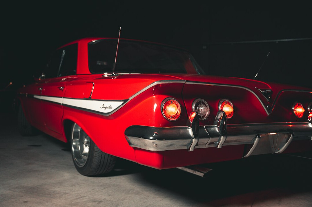 Professional camera equipment set up to photograph a classic automobile in a studio